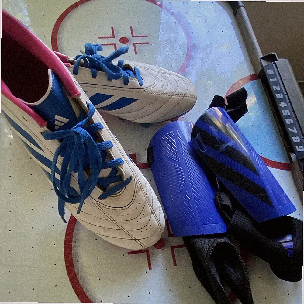 adidas woman’s White/Blue/Pink Lace-Up Low Top Soccer Cleats, Plastic Studs