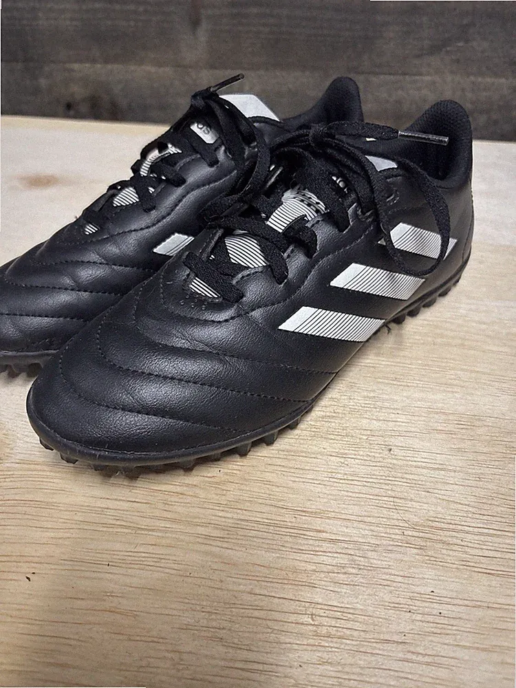 Black and white adidas Goletto VIII soccer shoes designed for turf surfaces.