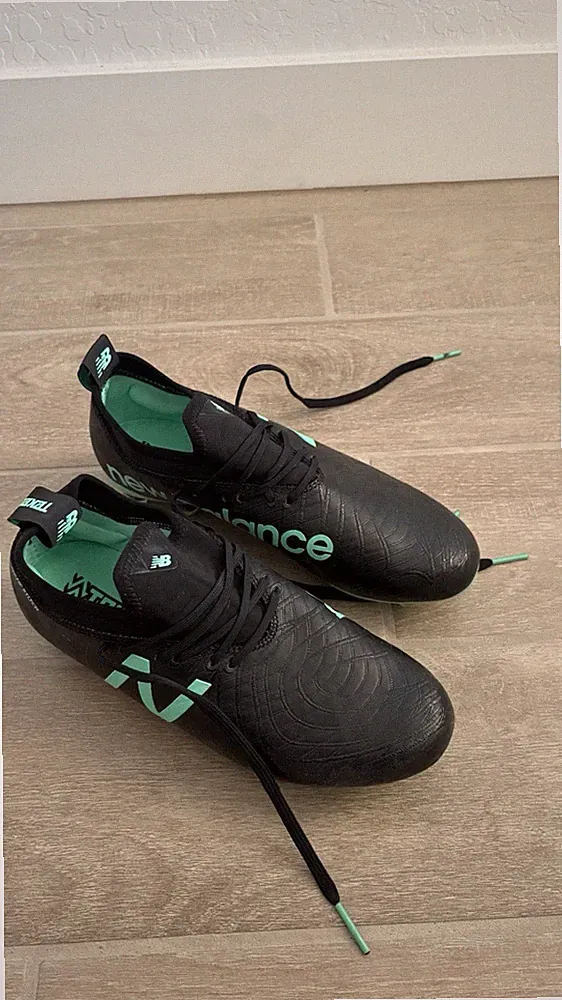 New Balance Black Soccer Cleats with Mint Green Accents