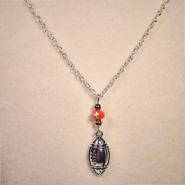 SILVER FOOTBALL AND ORANGE BEADED PENDANT ON SILVER CHAIN